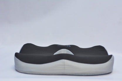 A contoured support cushion with a black top layer and a light gray base, shown against a plain light gray background.