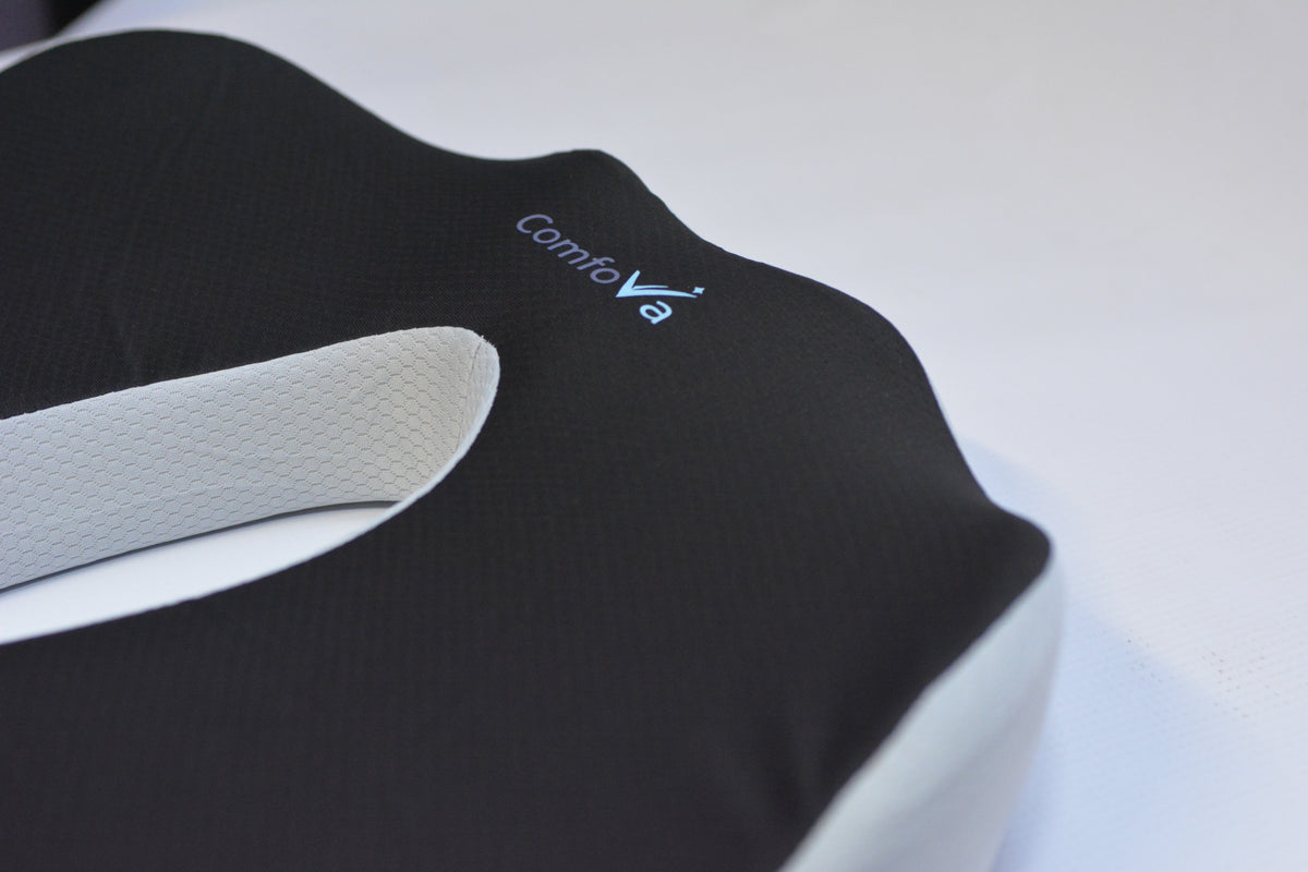 Close-up of a Contivo contoured support pillow with a black textured top and a white inner layer, showing the Contivo brand logo.