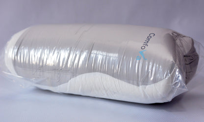 A Contigo pillow wrapped in clear protective plastic packaging, showing its white and gray contoured shape against a light gray background.