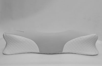 A white ergonomic neck pillow with quilted side panels and a smooth curved center, shown on a neutral light gray background.