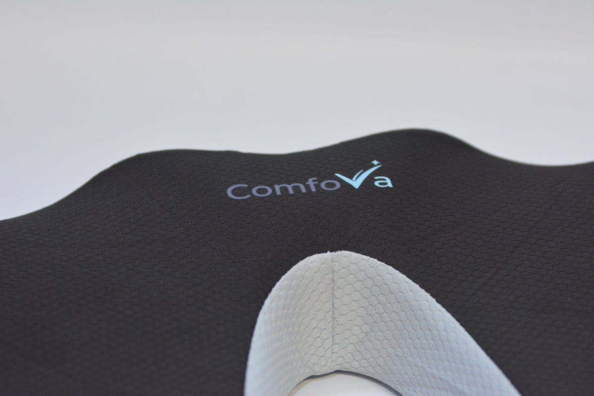 Close-up of a black textured Contour Comfort Support Pillow with the ComfoVa logo, showing a white support insert.