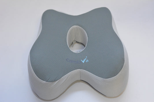 A ContourVa lumbar support pillow with a gray top cushion and a beige textured side base, shown on a plain white background.
