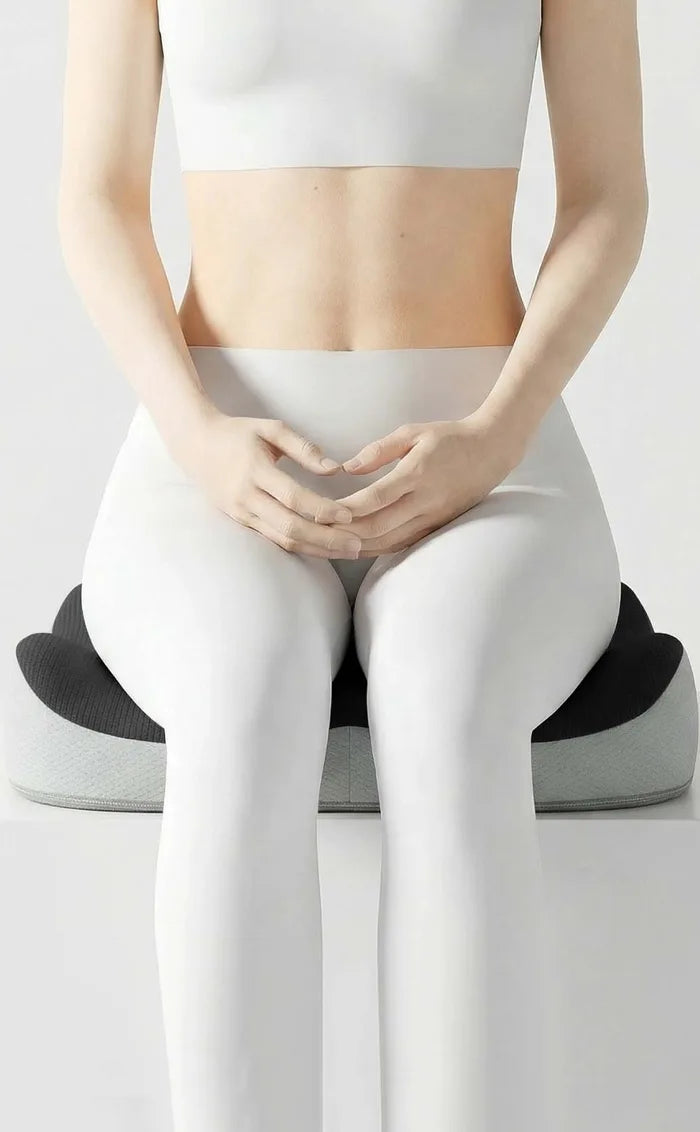 A woman seen from the front, sitting with her thighs in the cushion's two front curves